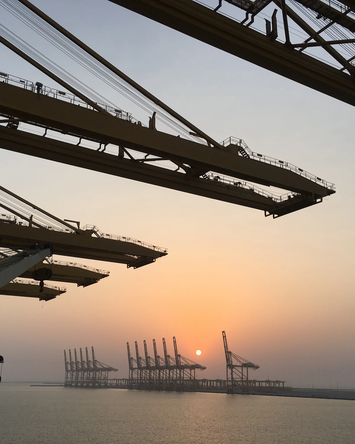 Port cranes at Mina Jebel Ali at sunset