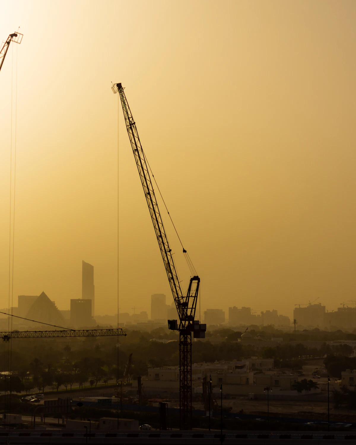 Construction crane in desert haze, Dubai