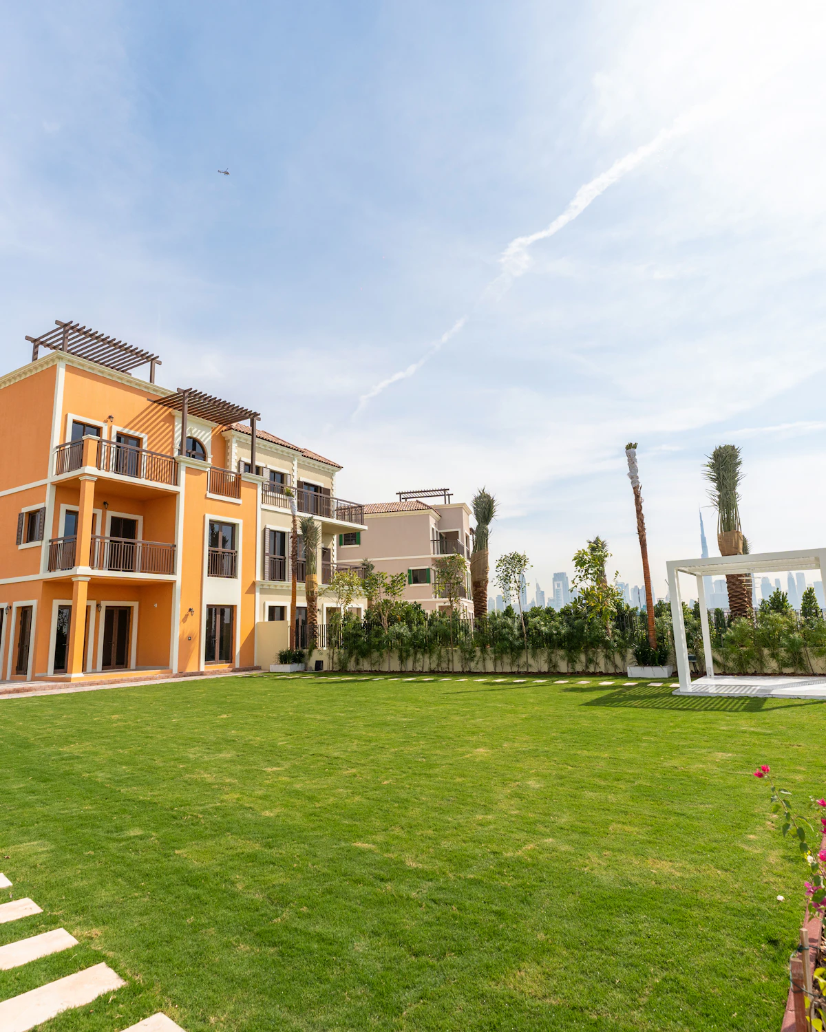 Townhouses beside a landscaped lawn in Dubai