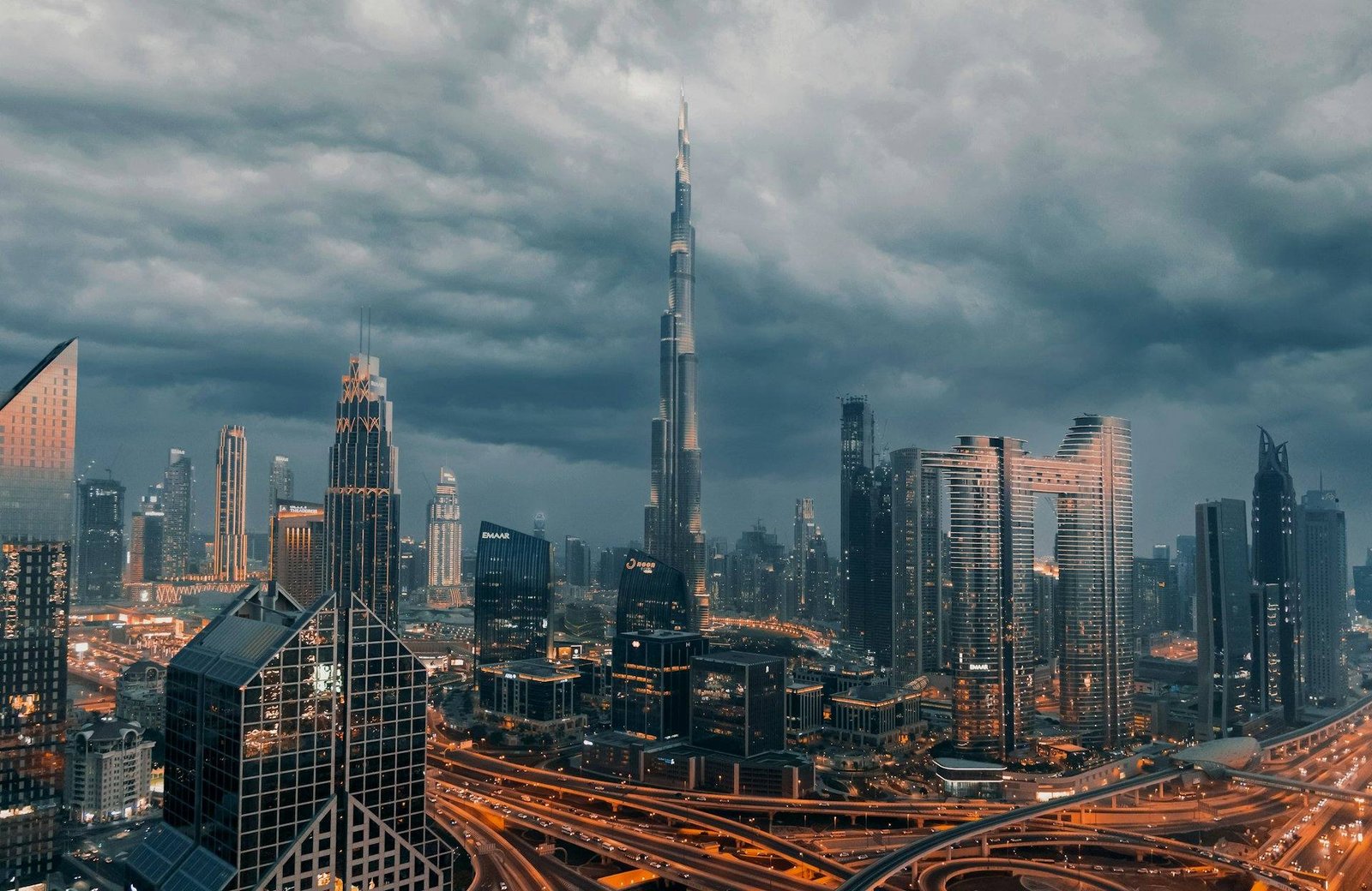 Downtown Dubai skyline and highway interchange under storm clouds